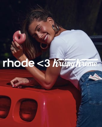 Hailey bieber with donut advertising for rhode strawberry glaze lip treatment